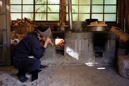 Starting the fire with traditional tools.